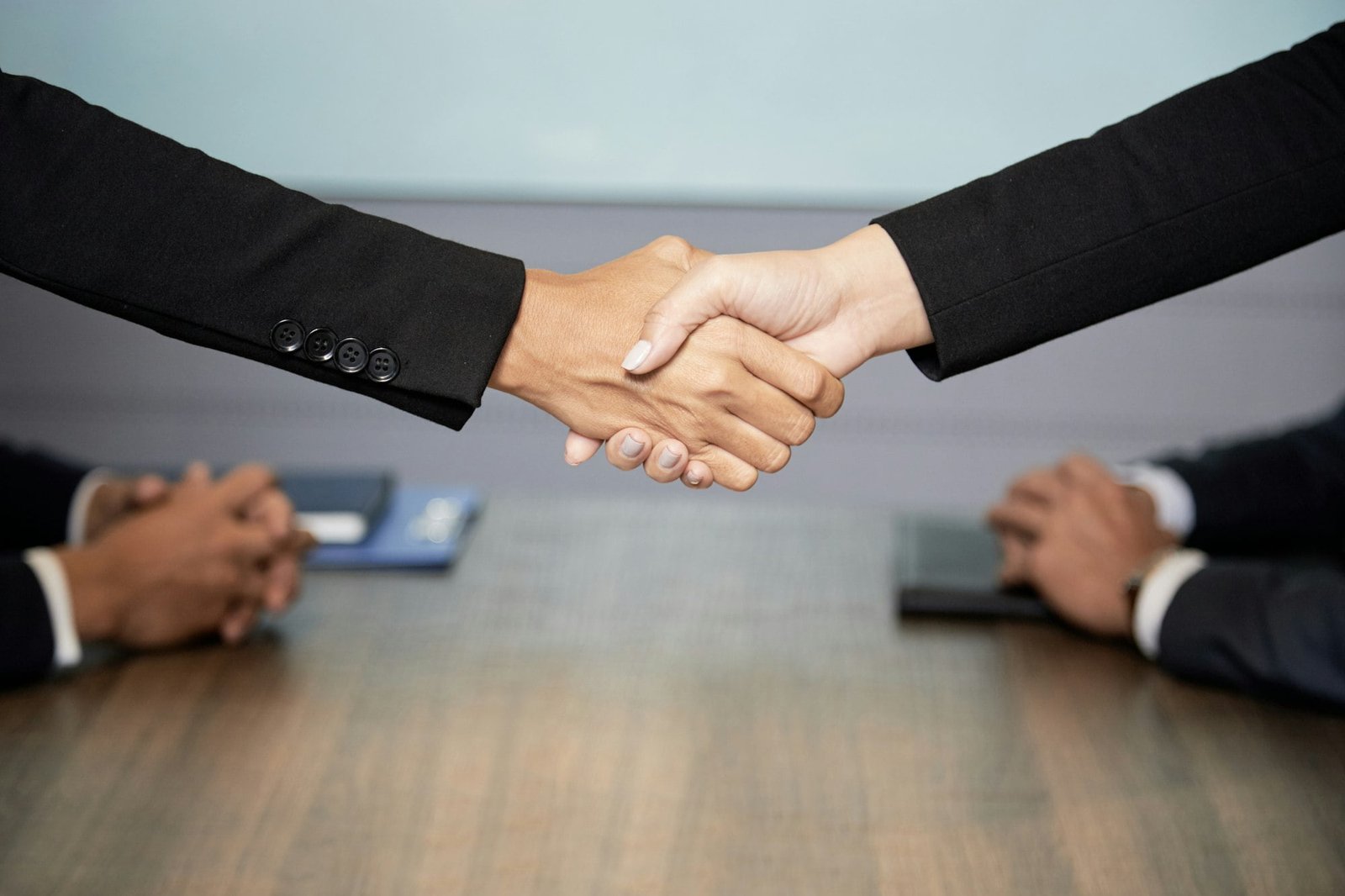 Crop businesswomen shaking hands